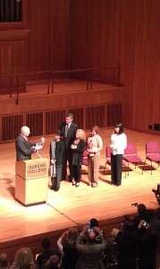 Photo by Amna Shams Aung San Suu Kyi accepts the Unisphere trophy from QC Alum Congressman Joseph Crowley, QC President James Muyskens, Grammy award winning singer Carole King, City Council Speaker Christine Quinn and Actress Anjelica Houston. 