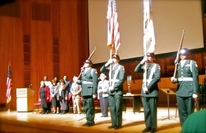 People stand for the national anthem at the annual Kristalnach commemoration at Queens College. PHOTO BY CHRISTOPHER BOYCE.